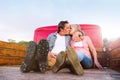 Senior couple sitting in back of red pickup truck Royalty Free Stock Photo