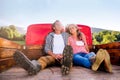 Senior couple sitting in back of red pickup truck Royalty Free Stock Photo