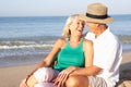 Senior couple sitting on beach relaxing Royalty Free Stock Photo