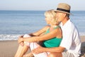 Senior couple sitting on beach relaxing Royalty Free Stock Photo