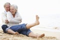 Senior Couple Sitting On Beach Together Royalty Free Stock Photo