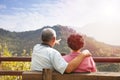 Senior couple sitting on the bench looking the nat Royalty Free Stock Photo