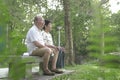 Senior couple sitting on bench in the park Royalty Free Stock Photo