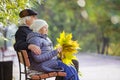 Senior couple sitting on bench in park Royalty Free Stock Photo