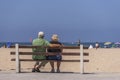 Senior couple sitting on boardwalk bench, Santa Monica, CA, USA Royalty Free Stock Photo