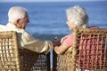 Senior Couple Sitting In Chairs Relaxing On Beach Royalty Free Stock Photo
