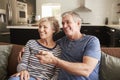 Senior couple sitting on couch watching television, close up Royalty Free Stock Photo