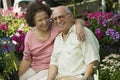 Senior Couple Sitting Among Flowers At Plant Nursery Royalty Free Stock Photo