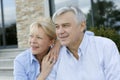 Senior couple sitting in front of house Royalty Free Stock Photo