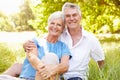 Senior couple sitting on grass together relaxing Royalty Free Stock Photo