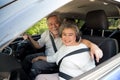 Senior couple sitting inside car enjoying trip and smiling happy with travel on the road. Royalty Free Stock Photo