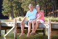 Senior couple sitting by lake Royalty Free Stock Photo