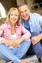 Senior Couple Sitting Outside House