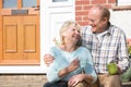 Senior Couple Sitting Outside House With Cup Of Coffee Royalty Free Stock Photo