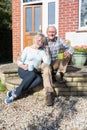 Senior Couple Sitting Outside House With Cup Of Coffee Royalty Free Stock Photo