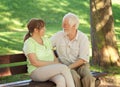 Senior couple sitting on a park bench Royalty Free Stock Photo