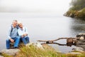 Senior couple sitting together by a lake Royalty Free Stock Photo