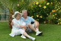 Senior couple sitting at tropic garden Royalty Free Stock Photo