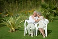 Senior couple sitting at tropic garden Royalty Free Stock Photo