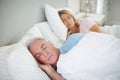 Senior couple sleeping on bed