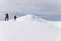Senior couple is snowshoe hiking in alpine snow winter mountains. Allgau, Bavaria, Germany. Royalty Free Stock Photo
