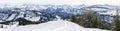 Senior couple is snowshoe hiking in alpine snow winter mountains panorama. Allgau, Bavaria, Germany. Royalty Free Stock Photo