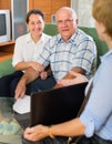 Senior couple with social worker at home Royalty Free Stock Photo