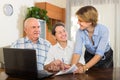 Senior couple with social worker at home Royalty Free Stock Photo