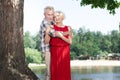 Senior couple spending time outdoors and hugging near the tree Royalty Free Stock Photo