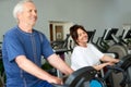 Senior couple spinning on fitness bikes. Royalty Free Stock Photo