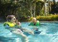 Senior couple splashing, playing, and having fun at a water park Royalty Free Stock Photo