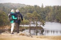 Senior couple standing embracing and admiring the view of a lake, back view Royalty Free Stock Photo