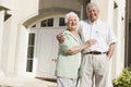 Senior couple standing outside house Royalty Free Stock Photo