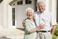 Senior couple standing outside house Royalty Free Stock Photo