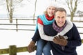 Senior Couple Standing Outside In Snowy Landscape