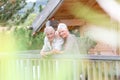 Senior couple standing on terrace on holdays