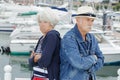 senior couple stood back to back after argument Royalty Free Stock Photo