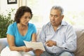 Senior Couple Studying Financial Document At Home Royalty Free Stock Photo
