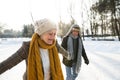 Senior couple in sunny winter nature ice skating. Royalty Free Stock Photo