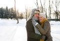 Senior couple in sunny winter nature ice skating, hugging. Royalty Free Stock Photo