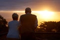 Senior couple, sunset and view on balcony in outdoors, bonding and love on vacation or holiday. Back, elderly people and