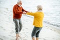 Senior couple in sweaters on the seashore Royalty Free Stock Photo