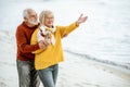 Senior couple in sweaters on the seashore Royalty Free Stock Photo