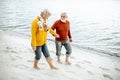 Senior couple in sweaters on the seashore Royalty Free Stock Photo