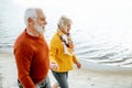 Senior couple in sweaters on the seashore Royalty Free Stock Photo