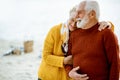 Senior couple in sweaters on the seashore Royalty Free Stock Photo