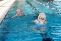 Senior couple swimming in pool Royalty Free Stock Photo