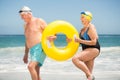 Senior couple with swimming ring at the beach Royalty Free Stock Photo