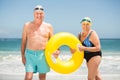 Senior couple with swimming ring at the beach Royalty Free Stock Photo