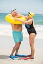 Senior couple with swimming ring at the beach Royalty Free Stock Photo